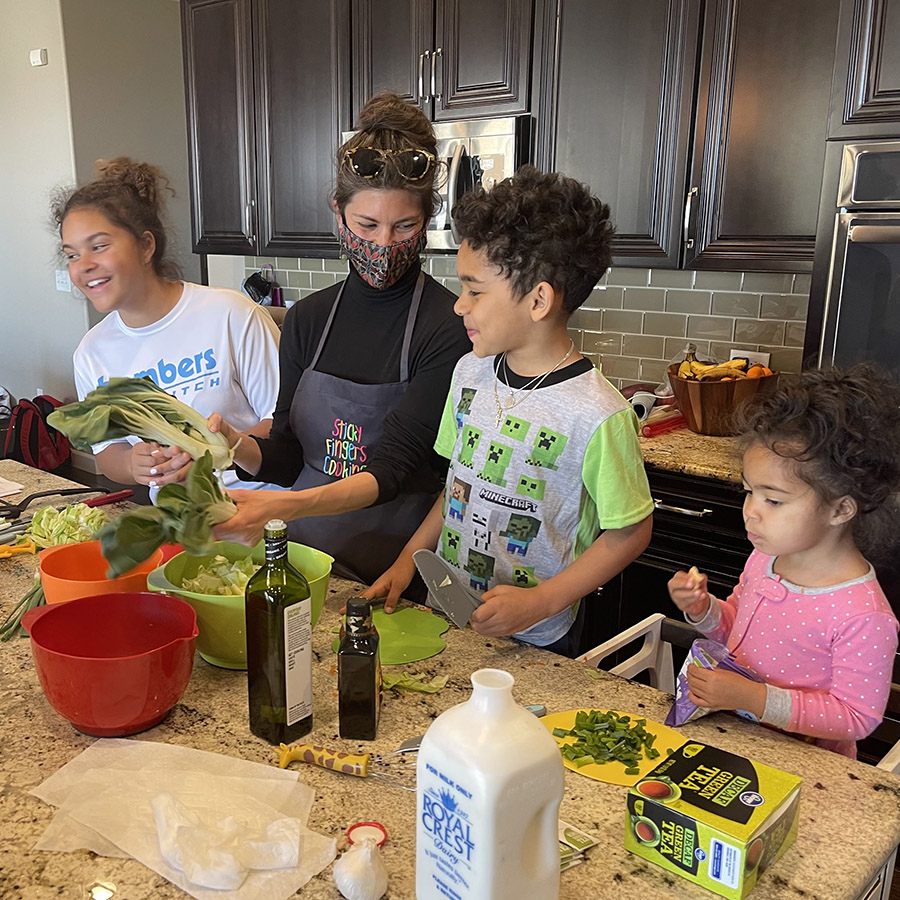 family enjoying a sticky fingers cooking private online cooking class